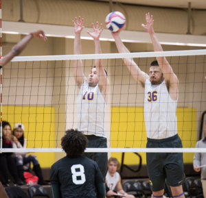 Team captain Nick Rusk (left) fired up his team after the second set.
EZEKIEL LEVIN / BEACON STAFF