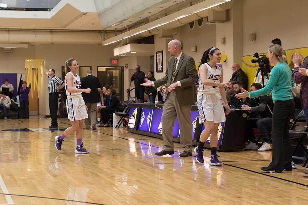 Maya Savino (3) and Eastin Ashby (43) are congratulated by head coach Bill Gould after being removed from Saturday's win over Mount Holyoke. Photo: Ashton Lyle/Beacon Correspondent