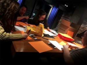 Sarah Heidrick and Shelby Broughton recorded the names of over 2,000 shooting victims on orange construction paper. Photo: Ally Rzesa/The Berkeley Beacon.