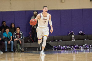 Geoff Gray (center) became the 18th player in college history to score 1,000 career points. Photo: Daniel Peden/Beacon Staff