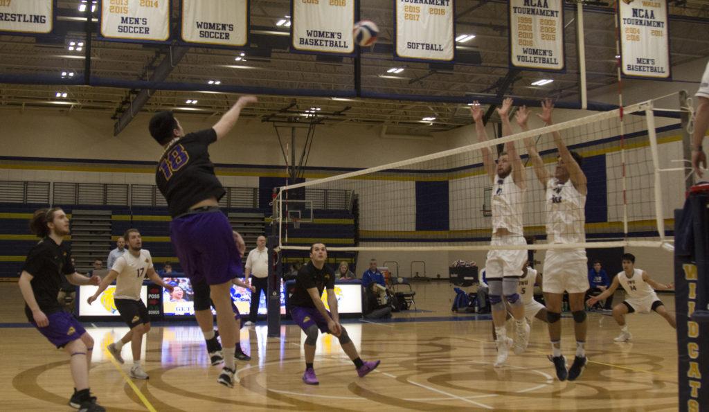 Win Kittivatcharapong (center, No.18) strikes a volley over the net. Photo by Kyle Bray / Beacon Staff