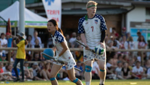 Tyler Trudeau (right, No.7) stands alongside teammate Xu Lulu in a 2018 IQA World Cup match. Photo courtesy of Miguel Esparza/USA Quidditch.
