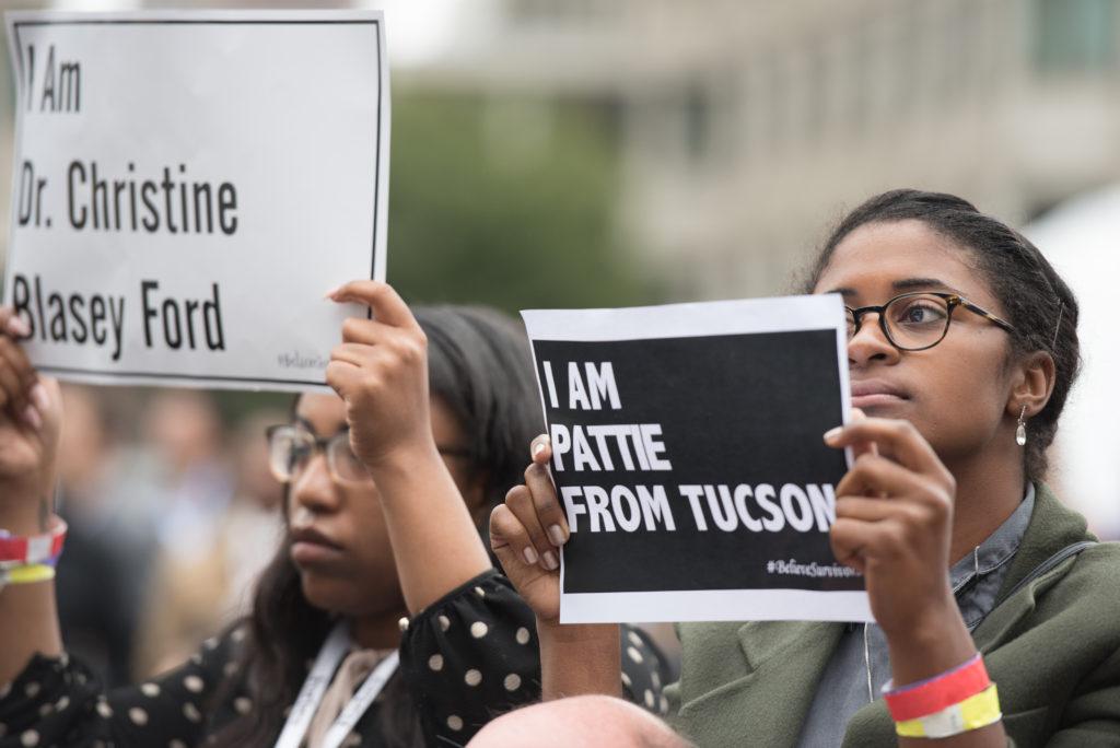 Morgan Payne (left), a senior at Texas Southern University, joined in on the silent protest at Sen. Jeff Flake's panel discussion. Cullen Granzen / Beacon Staff