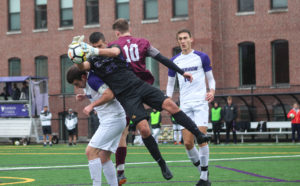 Creighton Dorfman (left) and David Kemp (center) collide after jumping up for a loose ball. Photo by Anissa Gardizy / Beacon Staff