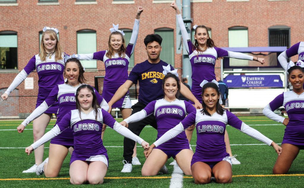 Ryan Rinaldi (center) poses with the Emerson Cheer Squad after finishing a routine. Photo by Anissa Gardizy / Beacon Staff