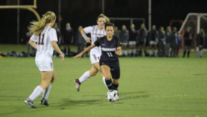 Veronica Alberts (No. 11) takes on two Springfield defenders. Photo by Anissa Gardizy / Beacon Staff