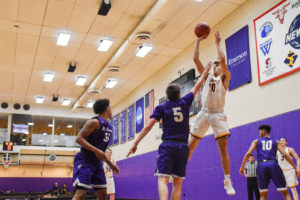 Freshman guard Zach Waterhouse (No. 10) shoots over an opponent on defense. Photo by Anissa Gardizy / Beacon Staff