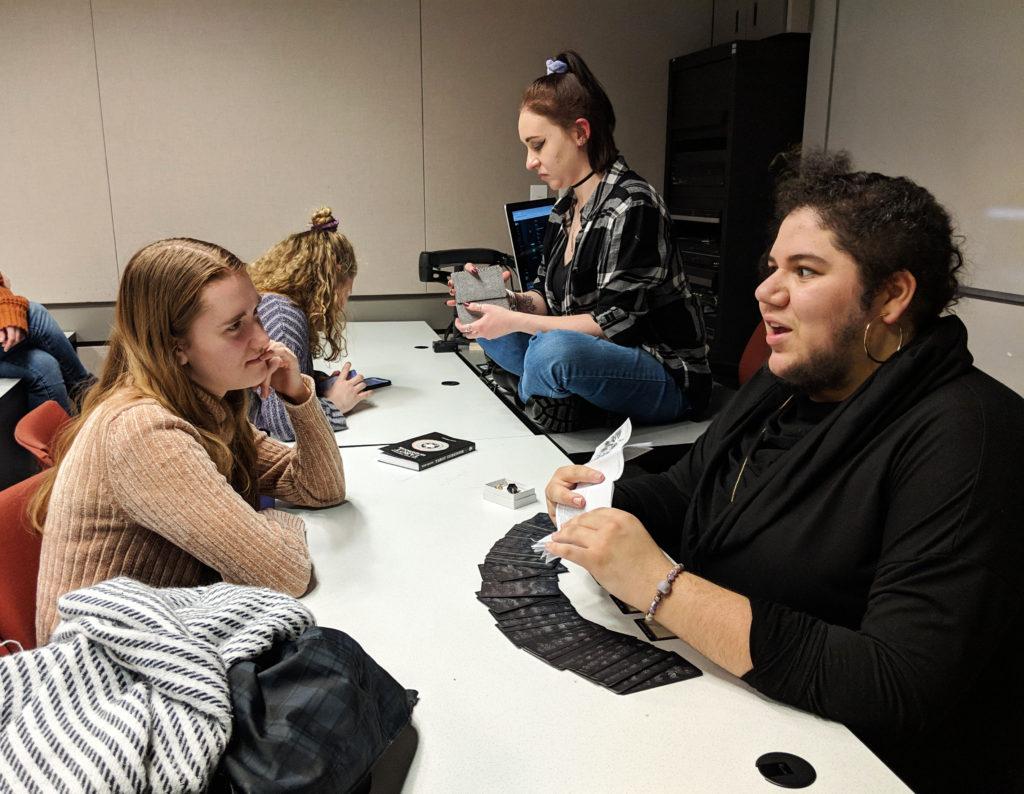 Lily Doolin (top right) and TJ Coste (bottom right) read Mystic members’ tarot cards at the first meeting of the fall 2018 semester. •  Courtesy of Kyle Eber