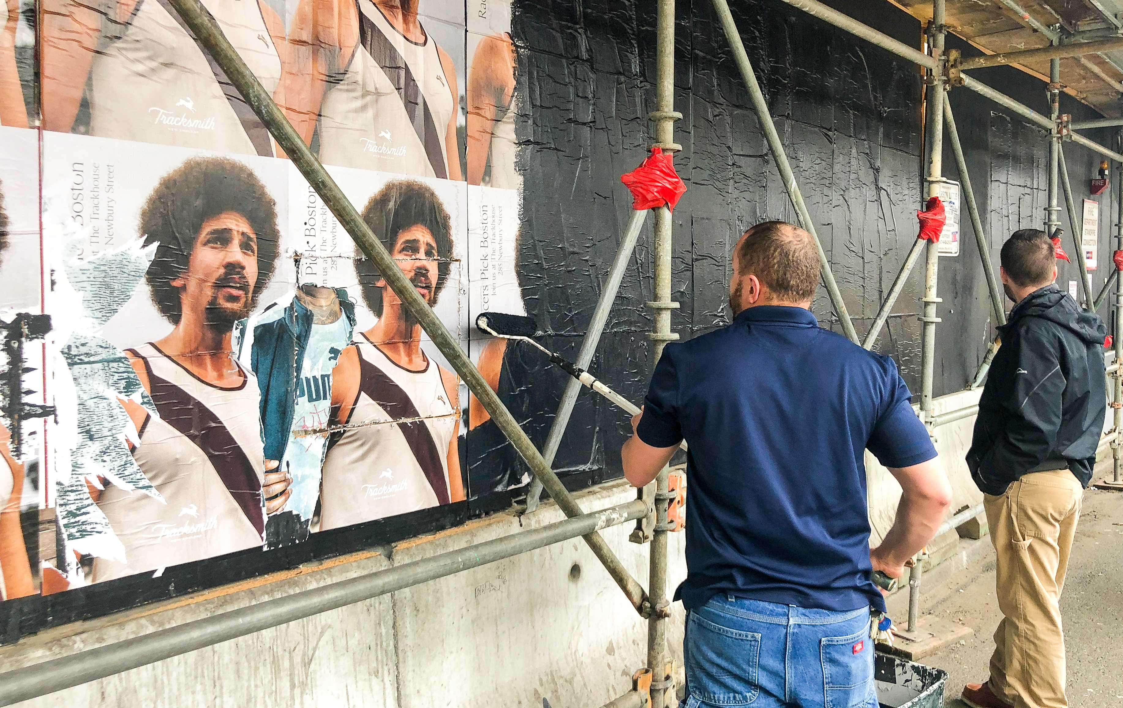 Workers painted over the scaffolding in front of Little Building where over over 12 students were publicly accused of sexual assault.