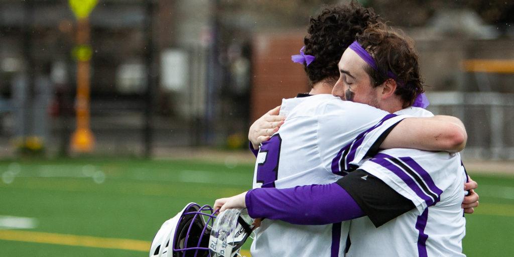 Freshman goalie Malcolm McGrath (left) hugs senior goalie Bailey Kennedy (right) after the mens lacrosse teams first conference win since 2013. Photo courtesy of Kate Foultz.