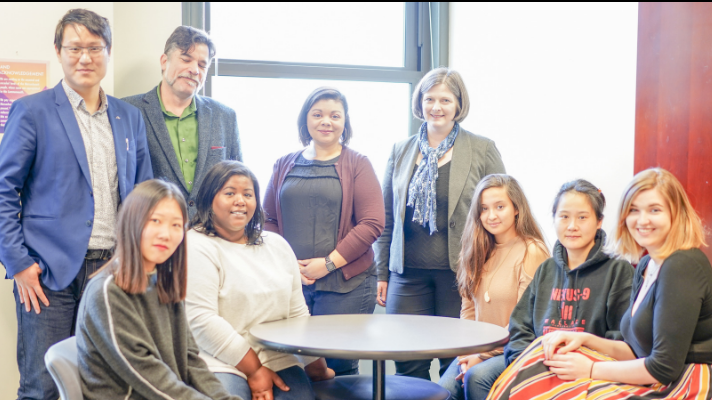 Andrea Popa (center), director of the Office of International Student Affairs, with international students in 2019.