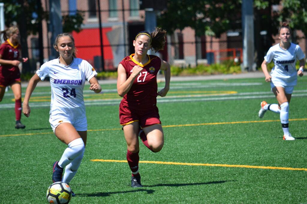 Freshman midfielder Ainslee MacQuarrie (left, No. 24) scored the opening goal in the Lions home opener against Regis College. Photo by Carol Rangel / Beacon Photographer