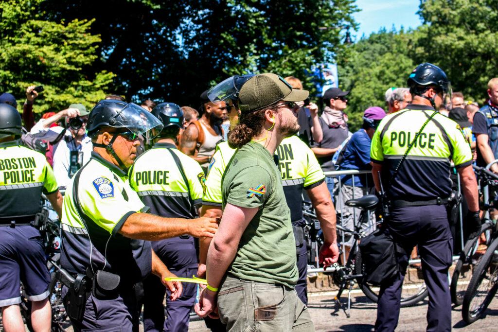 Boston police detain an individual during the Straight Pride Parade. Photo by Montse Landeros / Beacon Correspondent