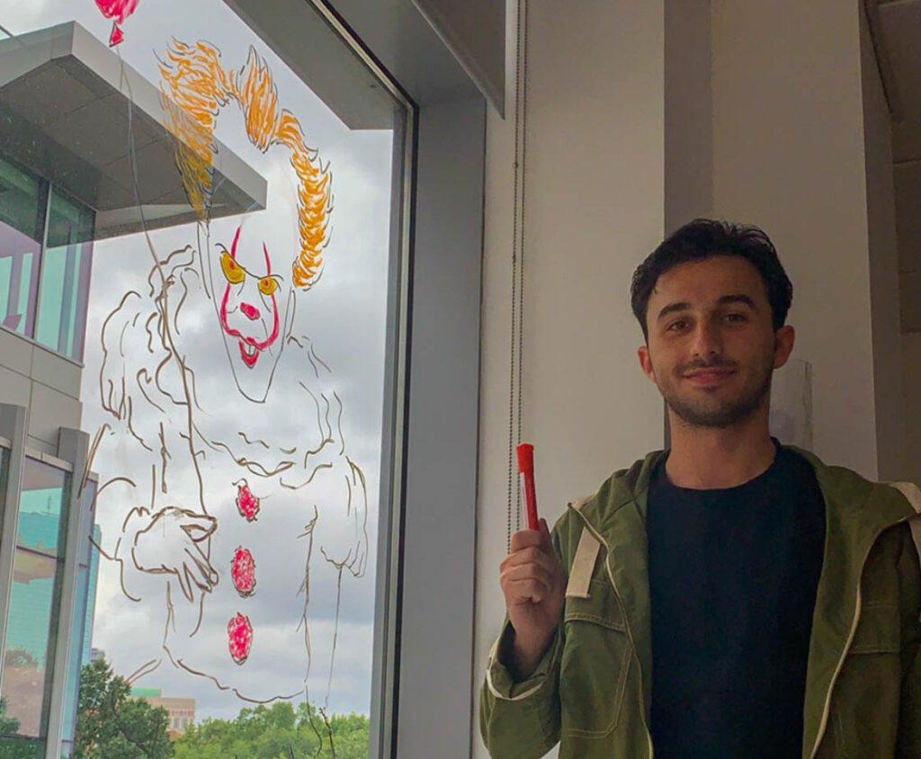 Senior Joe Scardilli grew up drawing—now he works for the SEAL office sketching memes on the new walls of 172 Tremont St. Courtesy of Joe Scardilli