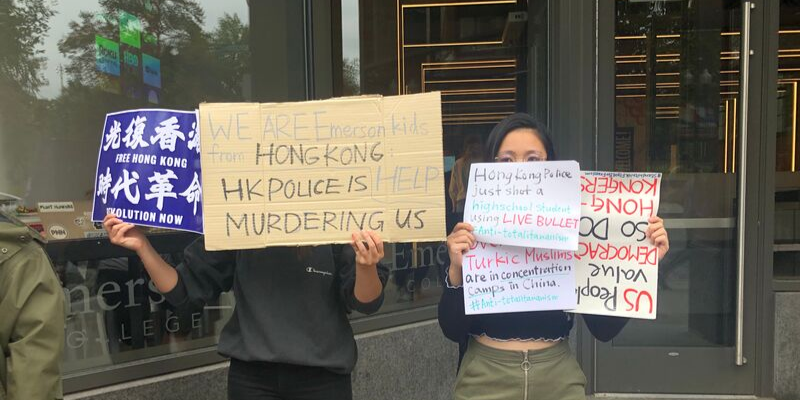 Frances Hui and Katerina Au stood outside the Dining Center to show their support for Hong Kong demonstrators.
