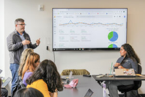 Assistant Director of SEAL Andrew Donahue gives a presentation on EmConnect's community impact at SGA joint session.