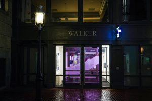 The alley entrance to the Walker building casts a beacon of light on the campus. 