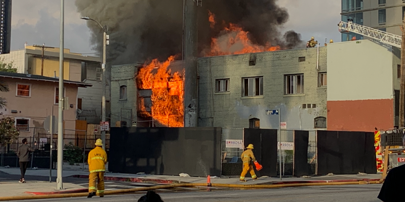 Firefighters attempt to extinguish a fire that broke out next to Emerson Colleges Los Angeles campus. 