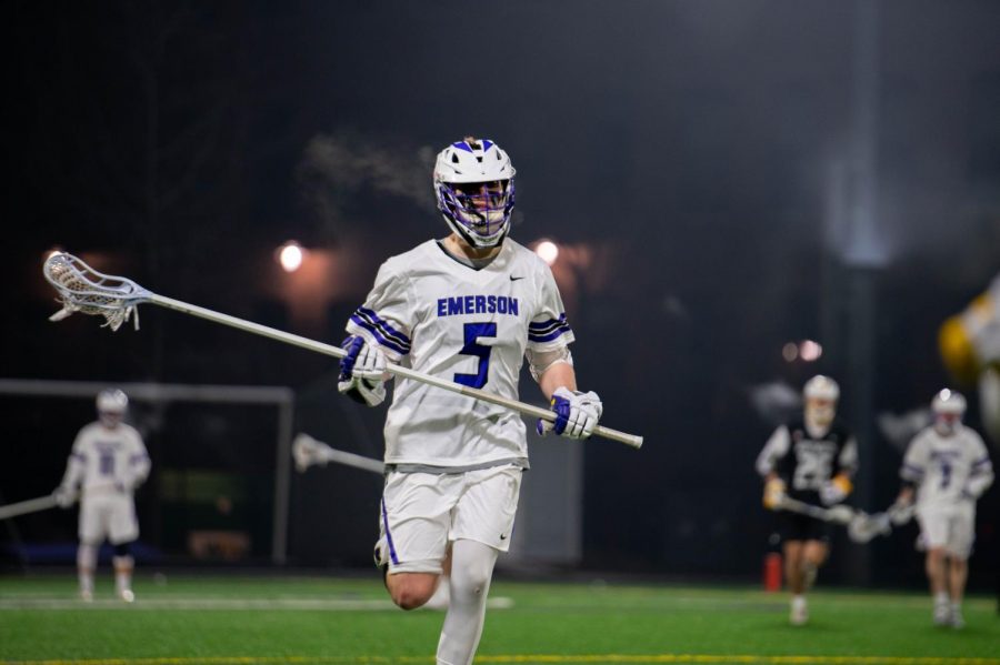 Junior Defender, Lucas Sickner, running down the field during a game.