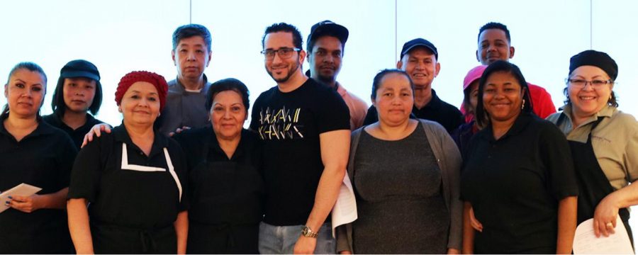 Daniel Suazo (front center), and most of his fellow dining center workers, are not receiving pay or benefits after their hours were eliminated in March.  