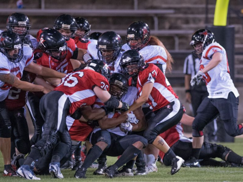 The Renegades team up for a tackle against a WFA opponent.