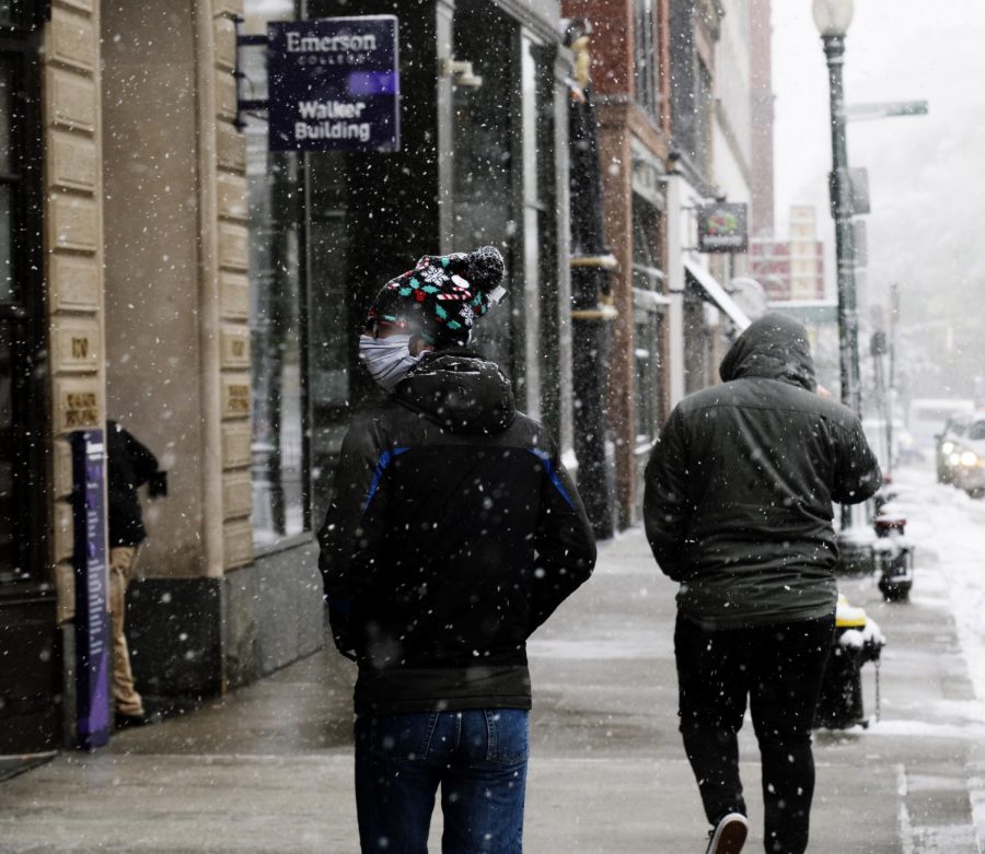 A student walks in the snow on Boylston Street
