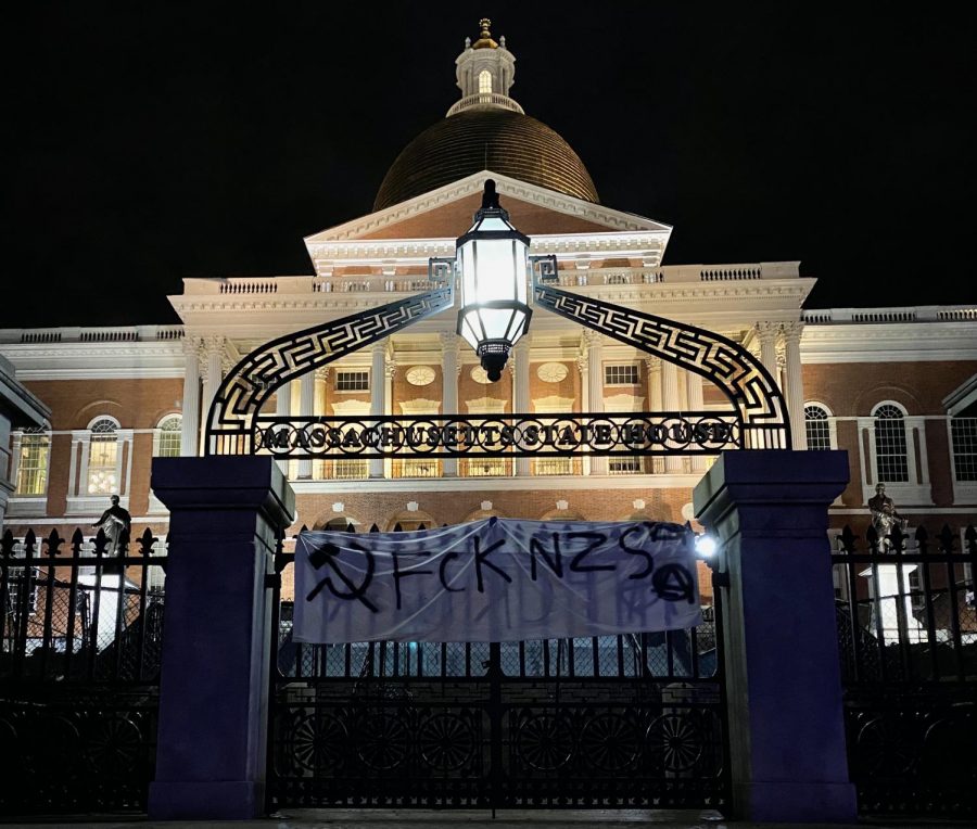 Following the protest Wednesday evening, the Massachusetts State House front gate holds a white flag with 