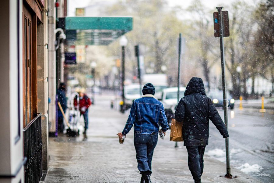 People walk on Boylston Street as the snow danced down. (Alec Klusza/ Beacon Archives, File)