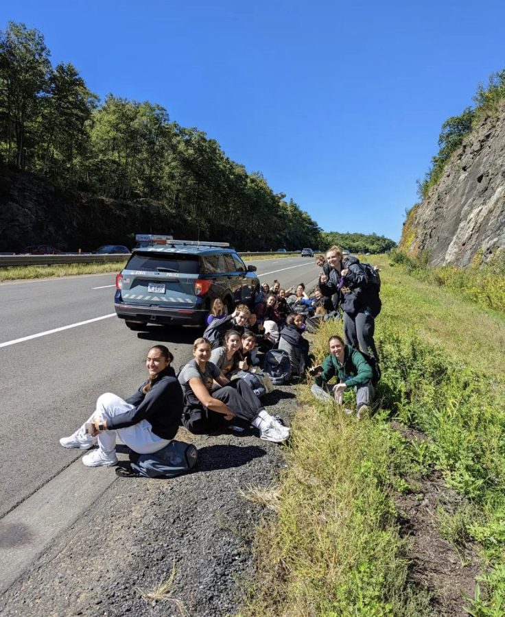 The womens volleyball team stranded on the side of the Mass. Pike. on Saturday, after their bus burst into flames.