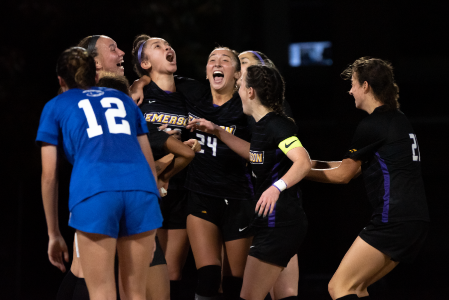 Emerson+womens+soccer+team+celebrating+following+a+late+goal+in+the+NEWMAC+quarterfinals.