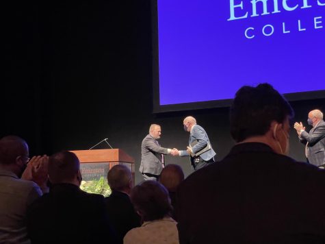Bernhardt shakes interim president Bill Gilligan's hand.