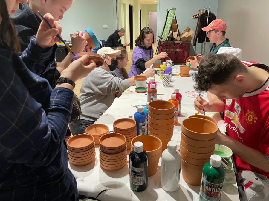 Attendees painting pots.