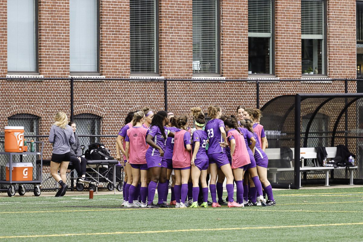 The+Emerson+womens+soccer+team+huddles+before+their+NEWMAC+opener+against+Smith+%28Sept.+16%2C+2023%29