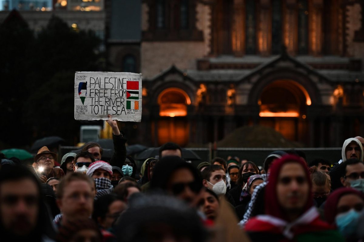 A+protester+hoists+up+a+sign+that+reads+Palestine+Free+From+the+River+to+the+Sea+during+the+All+Out+for+Palestine+rally+in+front+of+the+Boston+Public+Library+in+Copley+Square+in+Boston%2C+on+Monday%2C+Oct.+16%2C+2023.