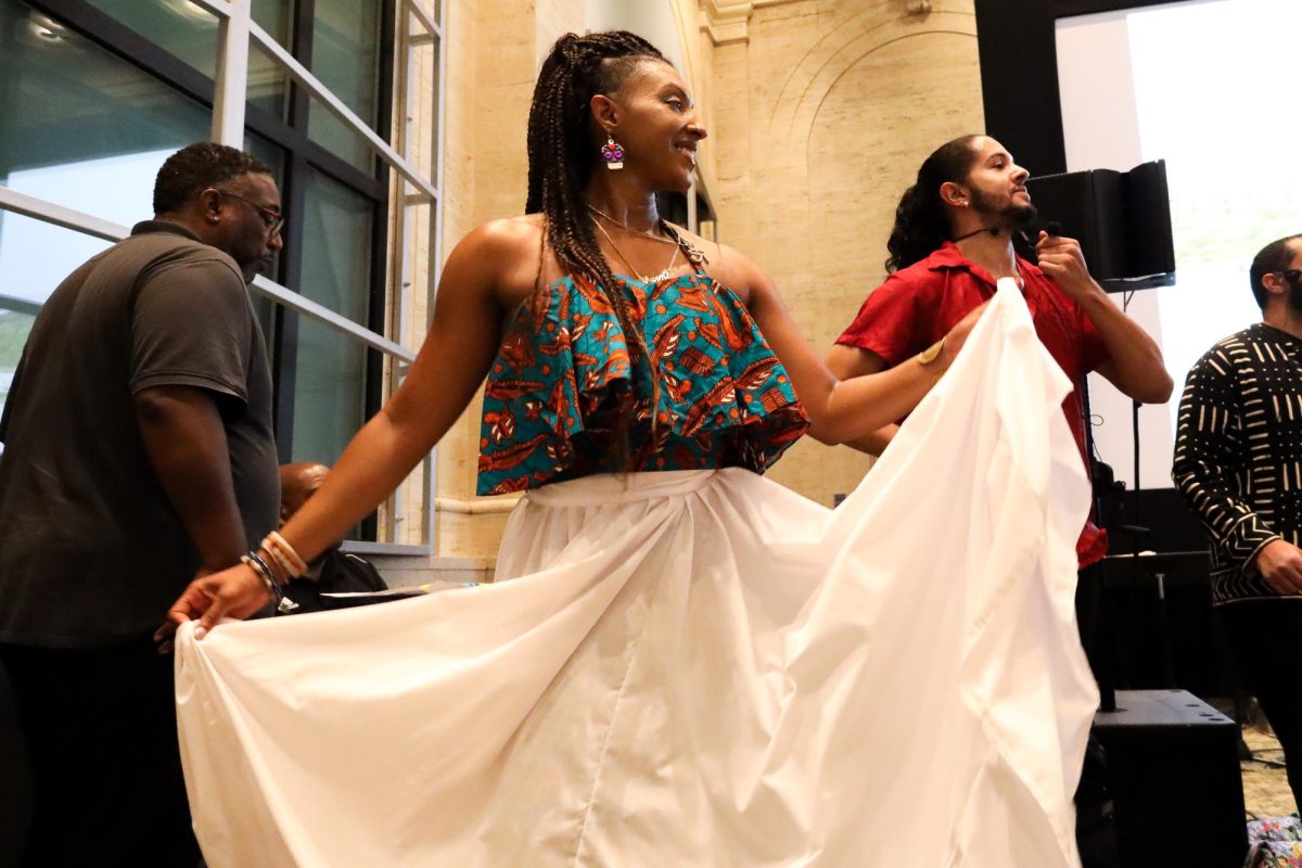 Charmaine Santiago Galdón dances next to her brother Marcel Santiago Marcelino at the Puerto Rico Beyond Reggaeton Event in Emerson College’s Bill Bordy Theatre last Wednesday night. (Madla Walsh for The Beacon)