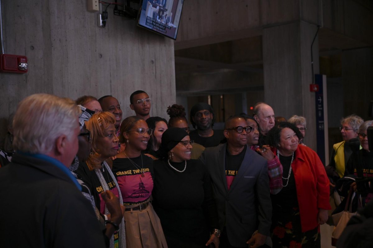 Boston City Counselor Tania Fernandes Anderson poses with #CHANGETHENAME supporters after a successful 10-3 vote on the proposed resolution at Boston City Hall on Wednesday, Oct. 25, 2023.