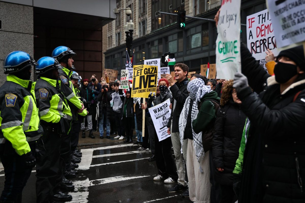 Protesters marching around the Ritz-Carlton hotel are stopped by police at the corner of Boylston Street and Washington Street on Thursday, Nov. 9, 2023. (Ashlyn Wang/Beacon Staff)