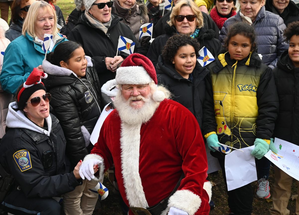 A man dressed as Santa Claus takes pictures with the crowd. (Nick Peace for The Beacon)