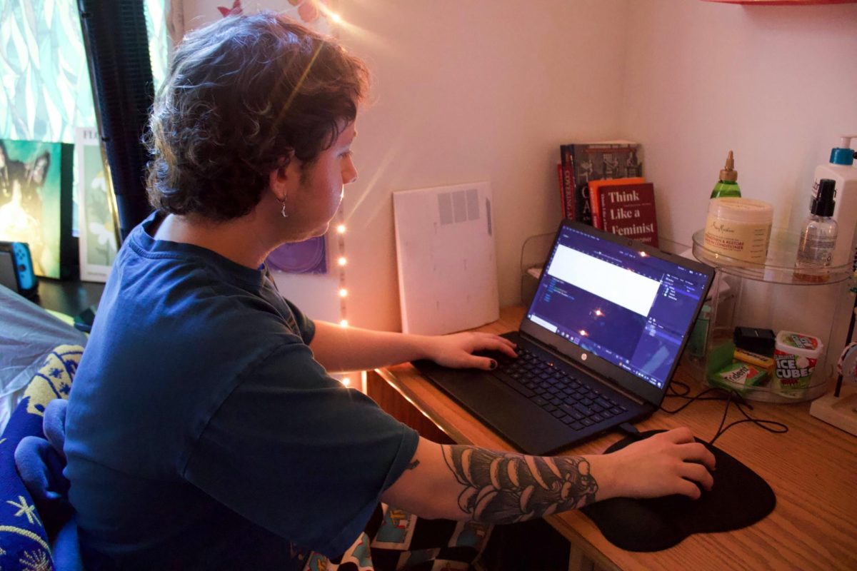 Kaden Bryant, a first-year writing, literature, and publishing major, works on coding for Emerson Generic Magazine.