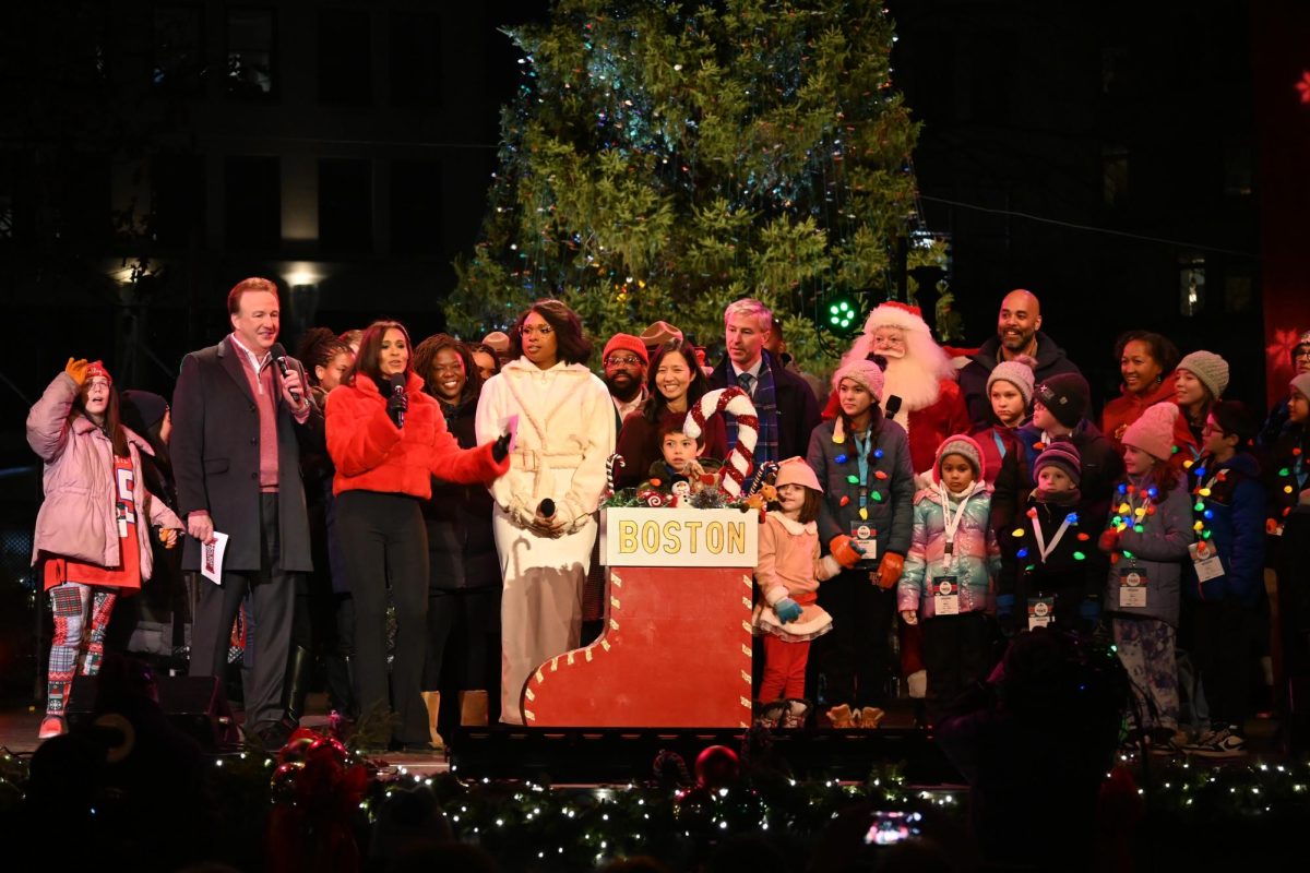Performers and viewers of the event join on stage to light the tree on Boston Common on Thursday, Nov. 30.