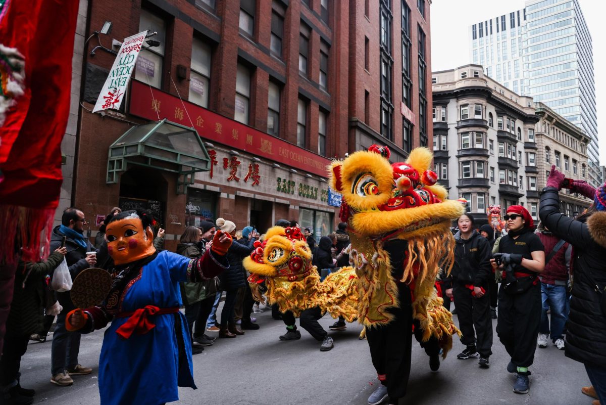 Lion dancers interact with spectators while performing during the parade in Bostons Chinatown on Sunday, Feb. 18, 2024. (Ashlyn Wang/Beacon Staff)