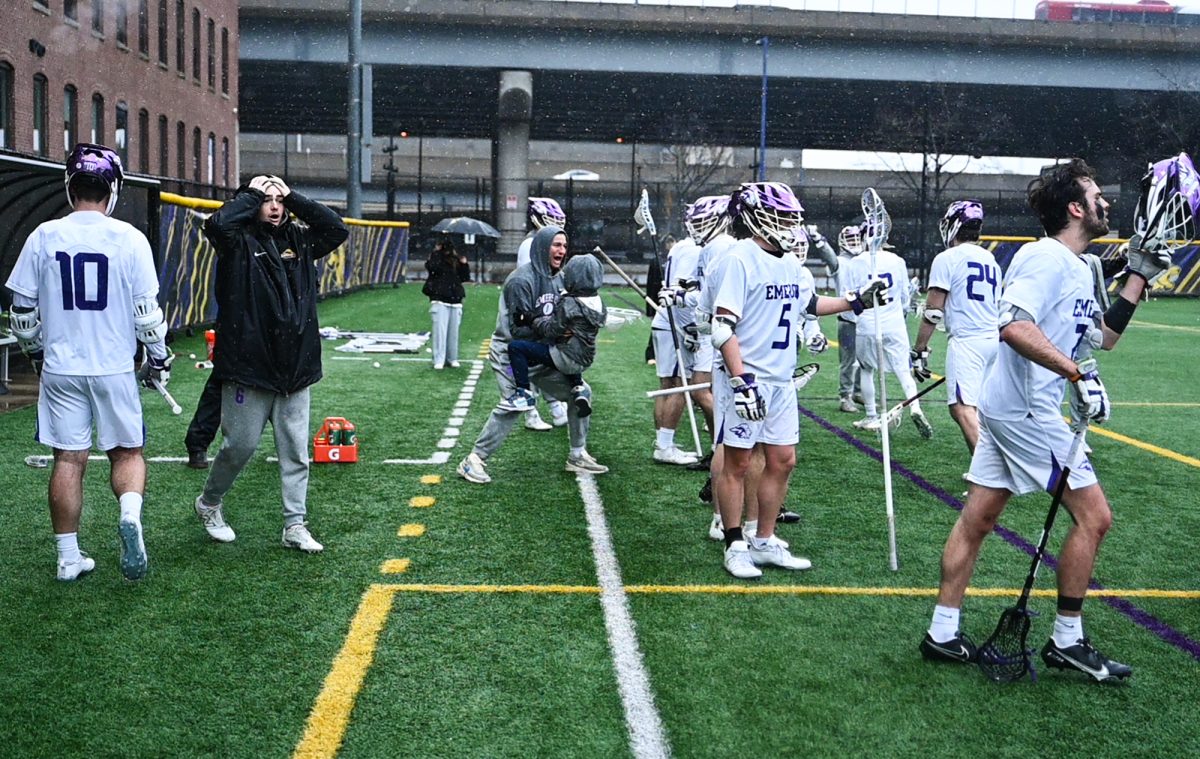 Emerson College men’s lacrosse team members and affiliates are surprised when they realize they have scored and are on the verge of winning during the third quarter of the game against Springfield College on Saturday, March 25, 2024. (Sasha Zirin/ Beacon Staff)