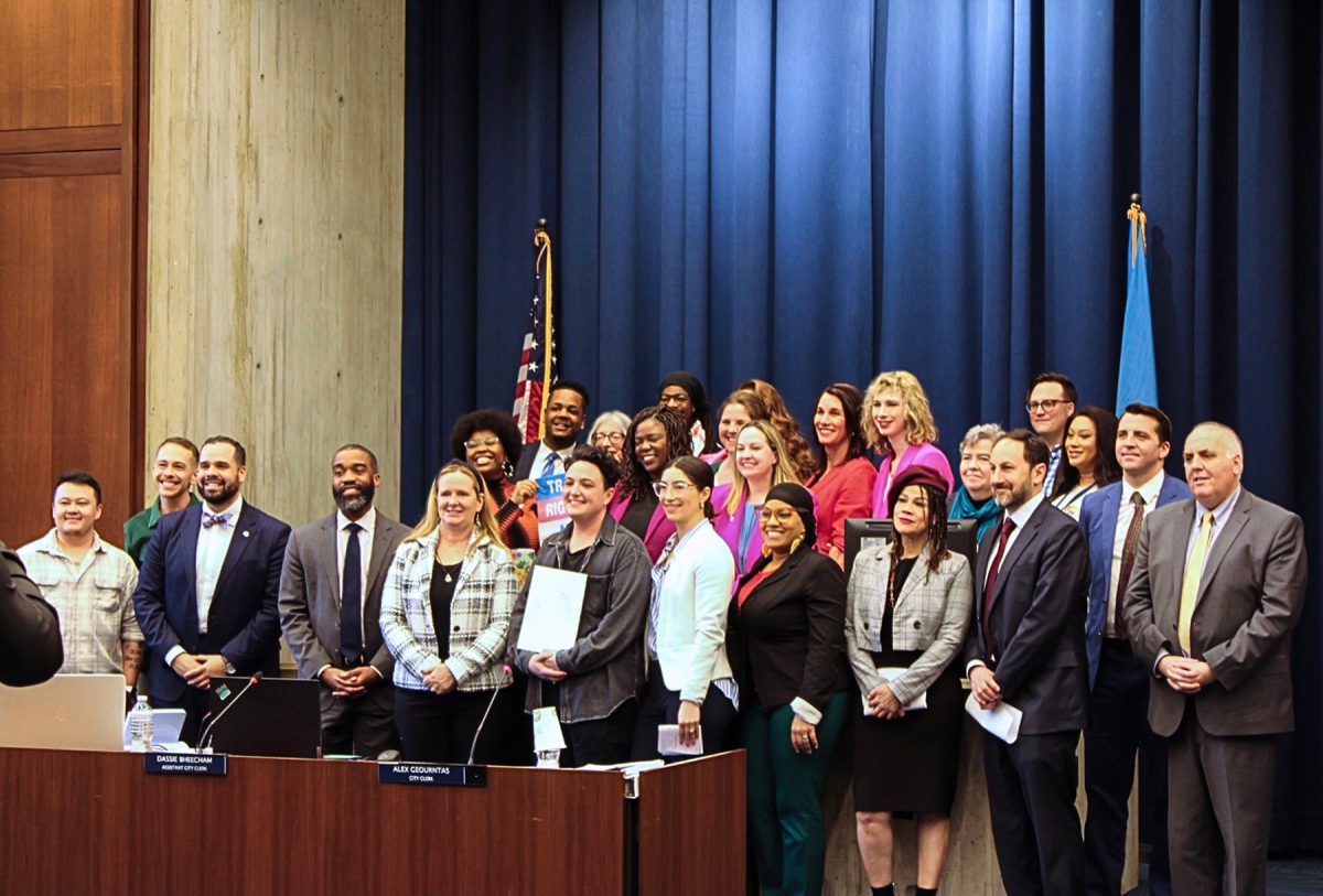 LGBTQIA+ community leaders, City Councilors, and members of the Mayor’s Office on LGBTQ+ Advancement pose for a group photo in commemorating Transgender Day of Visibility at the City Council meeting held on Wednesday, March 27, 2024. (DJ Mara/Beacon Staff)