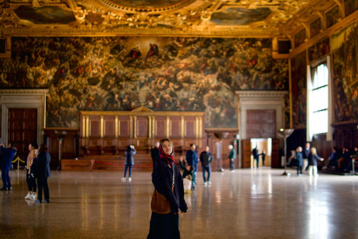 Sophomore marketing communications student Sam Switall stands in front of Il Paradiso, a canvas painting in the Grand Council Hall at the Doge’s Palace, a landmark building that was once the Doges residence and the center of the Venetian government, in Venice, Italy. (Photo courtesy of Samantha Switall)