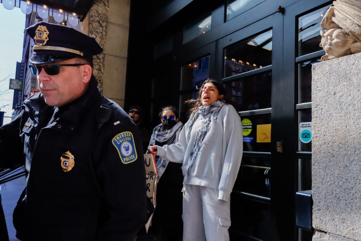 Protestors chant in front of the Cutler Majestic doors while Emerson College police and Boston police detain protestors on Friday March 22, 2024. (Arthur Mansavage/ Beacon Staff)