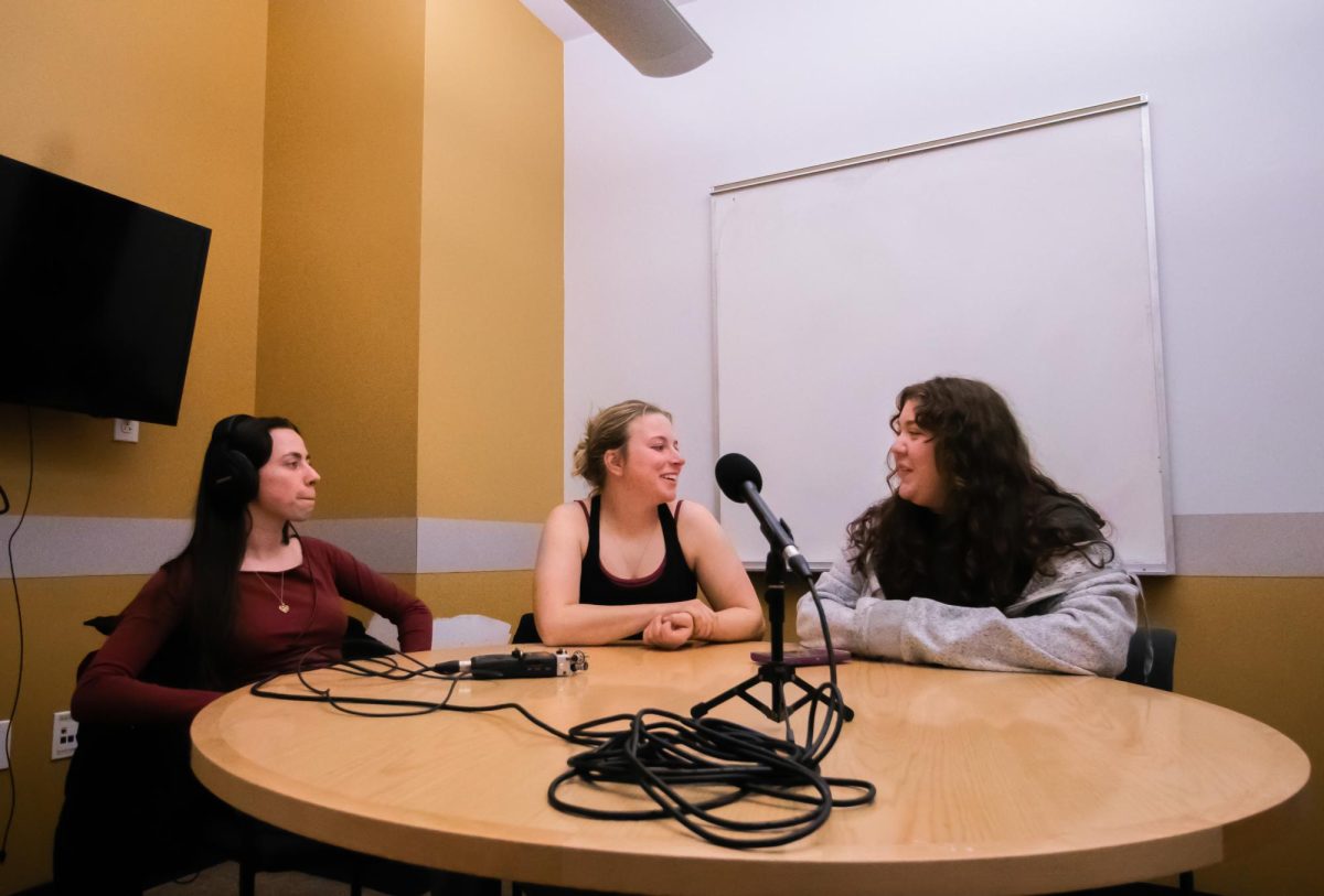 Sophomores Ashley Bradshaw, left, and Kayla Nuehlen, middle, interview Elle Baray-Forgét, right, for their podcast, ShutUp! on Sunday, April 7, 2024. (Naia Driscoll/Beacon Correspondent)