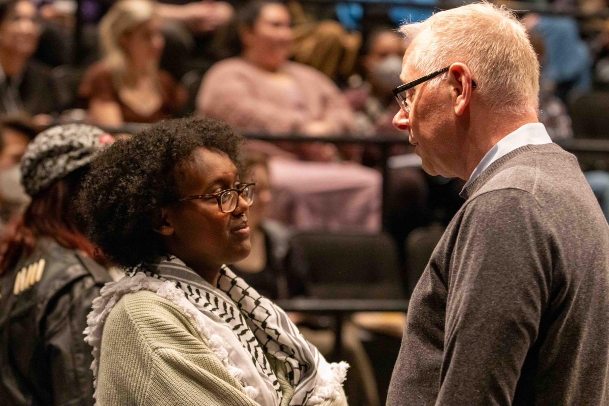 Juwaria, executive vice president of SGA and SJP organizer, speaks with Vice President and Dean Jim Hoppe before town hall starts on Monday, April 29, 2024. (Rian Nelson/Beacon Staff)