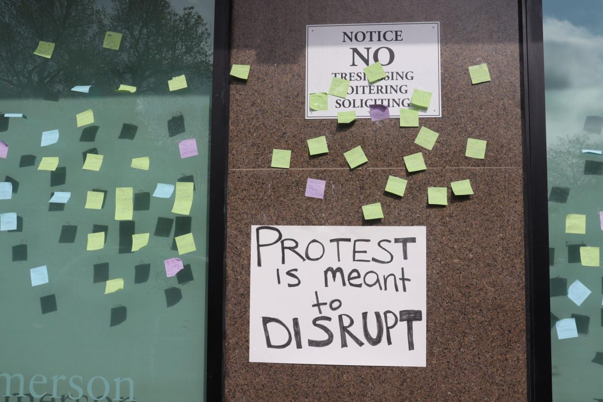Students left messages on the face of the Ansin building using sticky notes and posters, with the signatures of over 1,000 Emerson students who want ECSU to negotiate a contract with the college on their behalf. (Bryan Hecht/Beacon Staff)