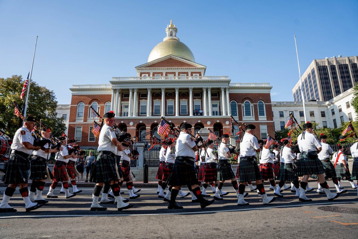 Members of the Greater Boston Firefighters Pipes and Drums (GBFPD) band march in front of the Massachusetts State House. (Yogev Toby/ Beacon Correspondent)