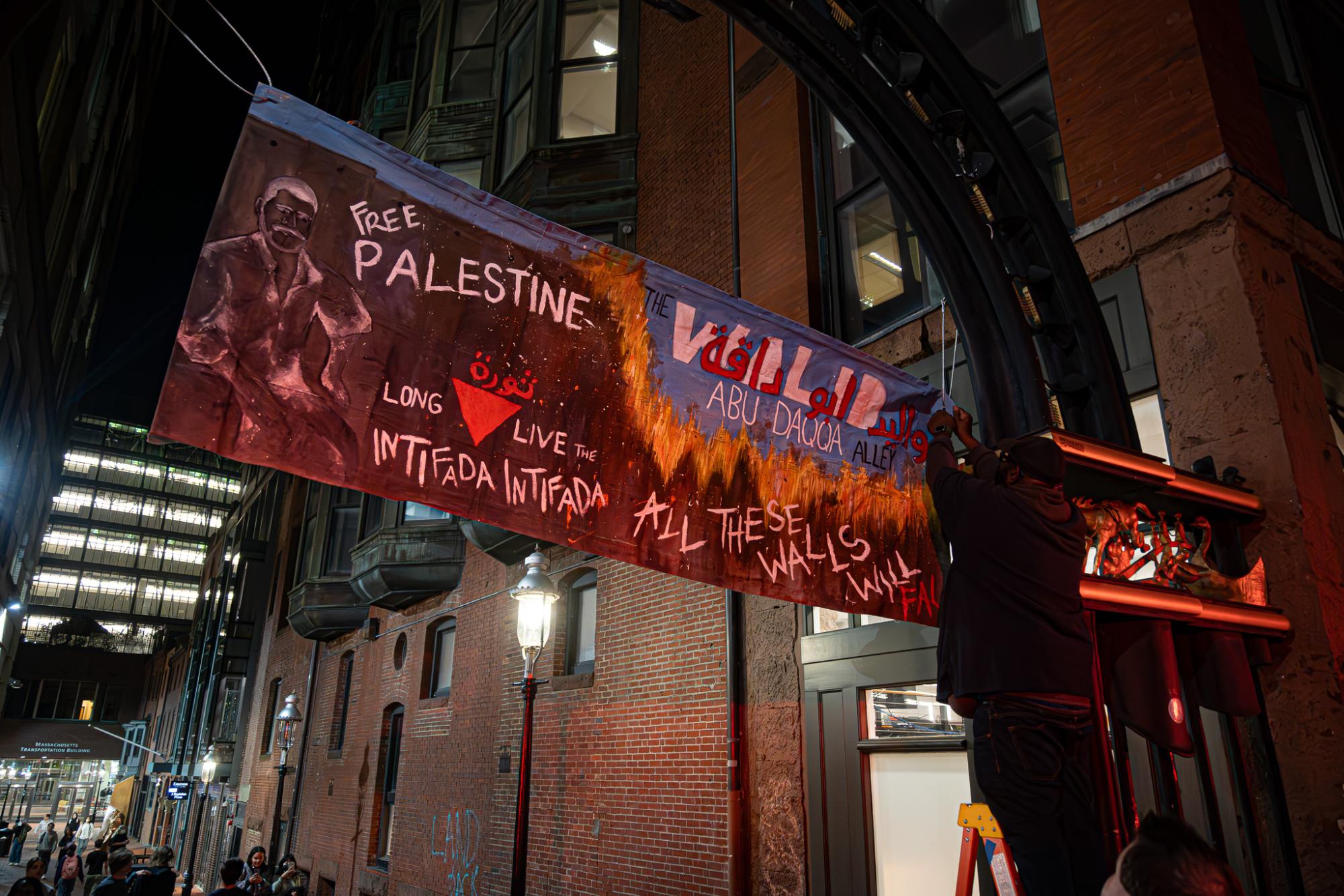 Dozens of pro-Palestinian protesters marched outside of the Israeli Consulate in Boston Tuesday before gathering in the Boylston Place Alleyway.